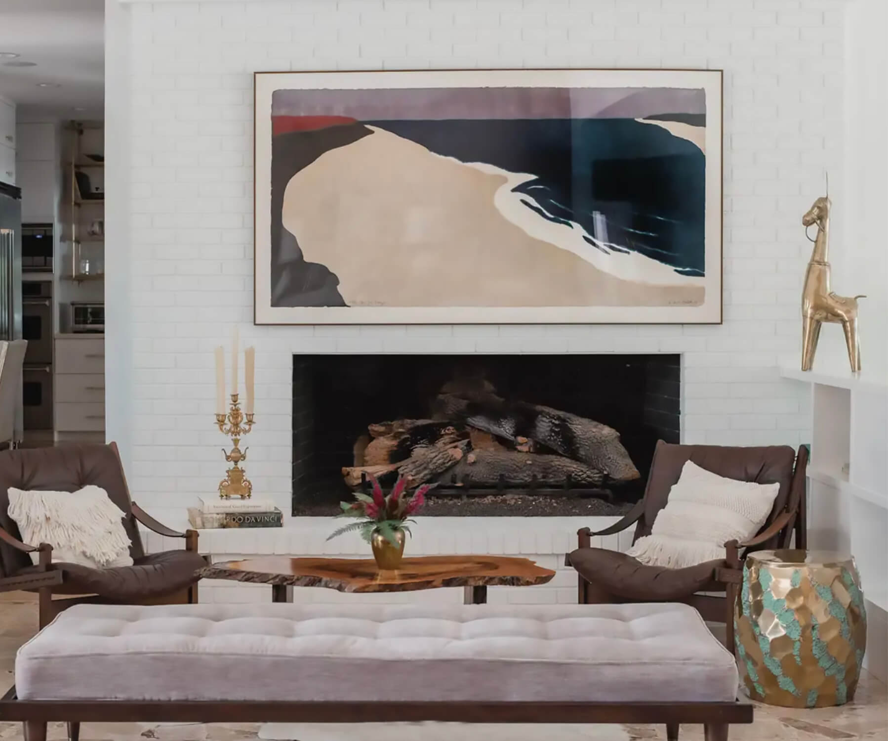 Eclectic living room with art, fireplace, and accents