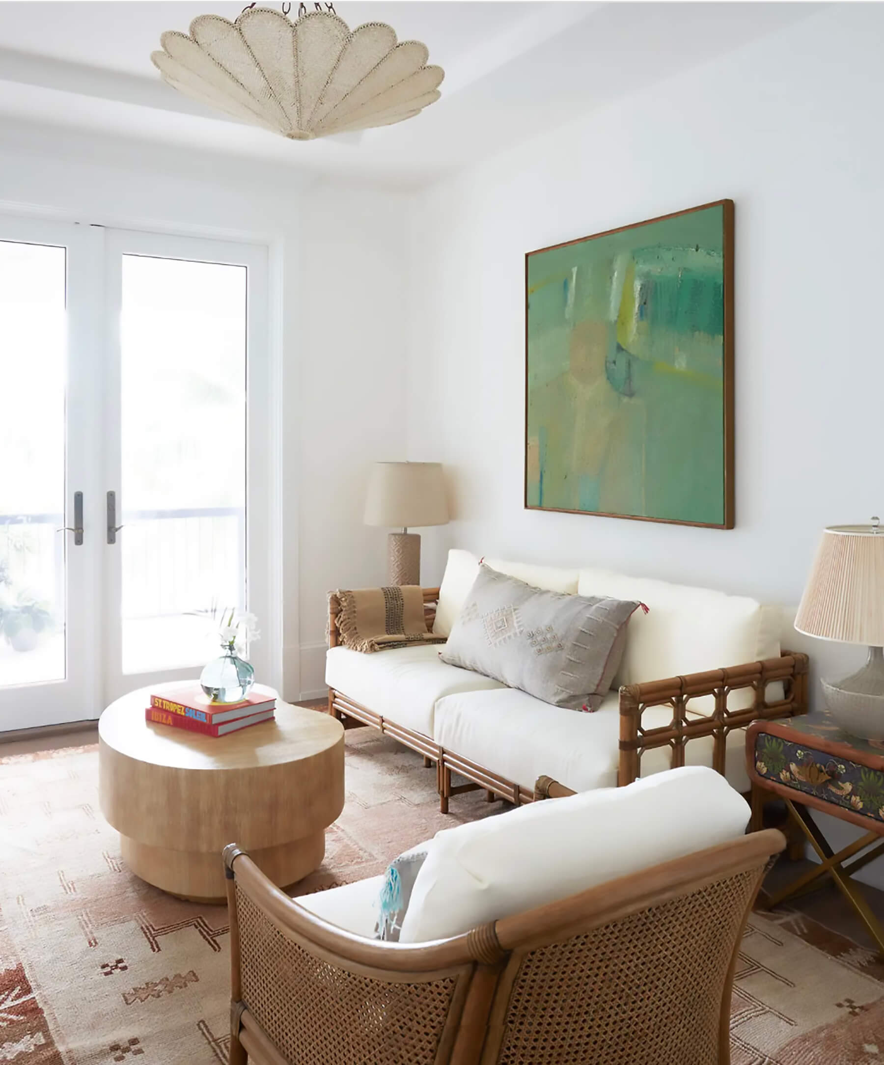 Rattan-framed sofa with green art