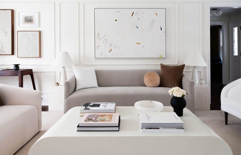 Minimalist living room with neutral-toned furniture and abstract wall art