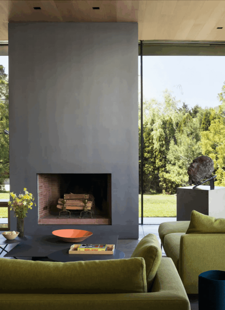 Contemporary living room interior with olive green sofas and fireplace